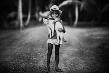 Child Carrying a Cat