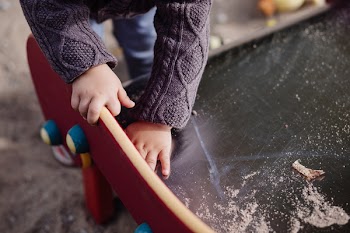 Child cleaning the slide