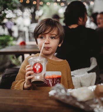 Child Drinking a Chocolate Beverage