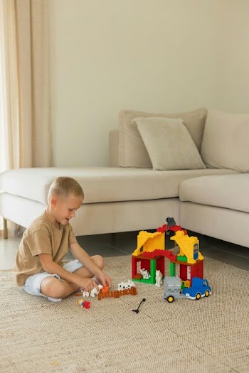 Child Engaged in Play with Colorful Building Blocks