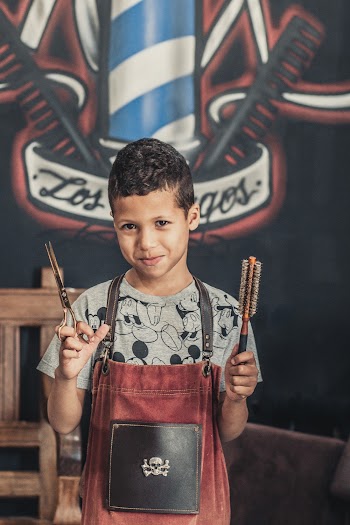 Child Holding Scissors and Brush