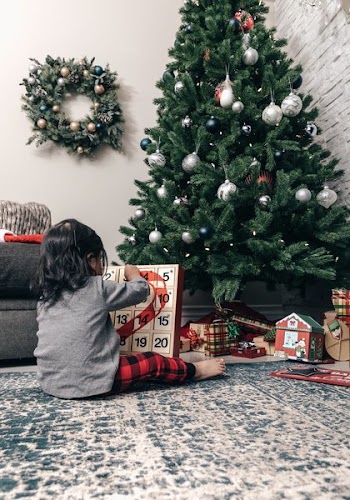 Child Opens Advent Calendar On Christmas Morning