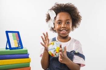 Child playing with globe in studio