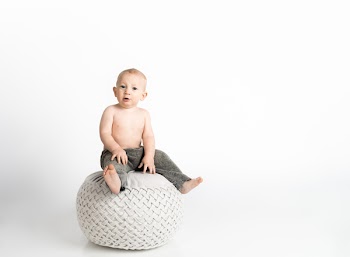 Child Sitting on White Stool