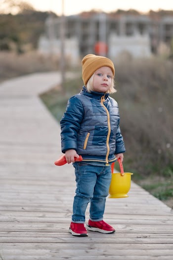Child Standing on Brown Wooden Beach Dock