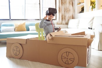 Children play in the cardboard car