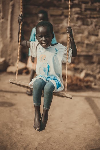 Children Riding On Swing