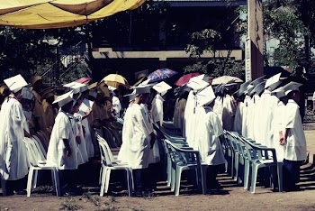 Children Wearing White Academic Gown during Graduation Ceremony at Daytime