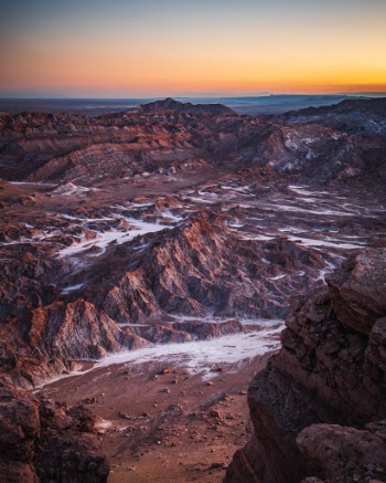 Chile's Valle de la Luna bathed in the soft light of the Atacama desert after sunset. I've talked before about how much I love the light in the desert. The air seems to create such a diffuse quality to the light around sunset, providing all sorts of pastel shades of color. Maybe it's the fine dust scattering the light. This is similar to a shot I posted a little bit ago, but at a later time. You can see how the bright golden light of the sun in the previous shot before sunset, changes into the soft, diffuse light of after sunset. 