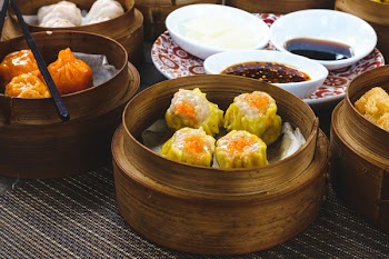 Chinese steamed and fried dim sum in wooden steamers 