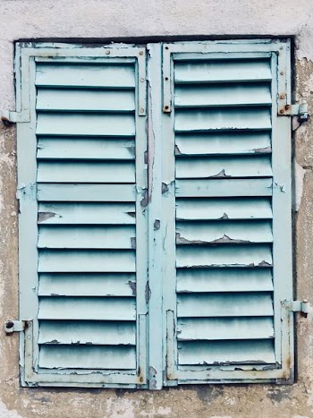 Chipped Blue Paint On Aging Shutters