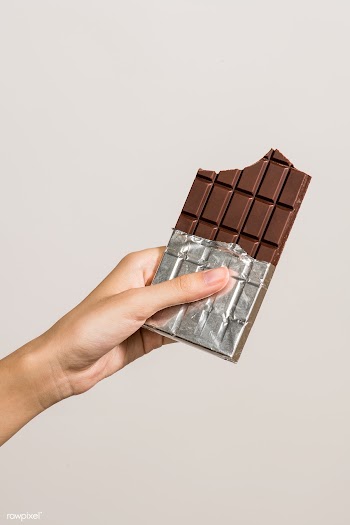 Chocolate bar in foil packaging isolated on background | Free  photo - 2299022