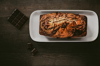 Chocolate Cake In White Plate Beside Chocolate Bars