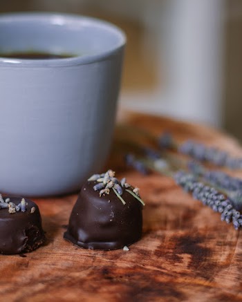 Chocolates Beside White Ceramic Cup
