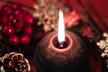 Christmas wreath and a round candle closeup 2