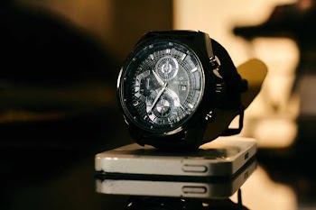 Chronograph Watch on Top of Smartphone