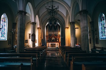 Church Pews Near Concrete Pillars in Church