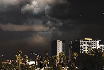 City Building Under Looming Dark Cloud Formation