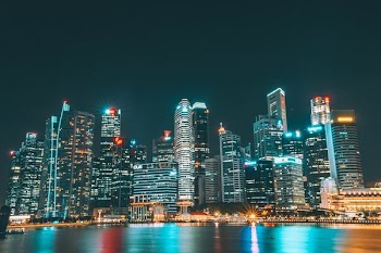 city lights under black clouds