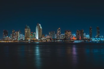 city near body of water during nighttime