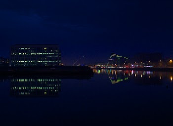 City Reflected on Water during Night Time