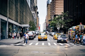 city street with people passing through road