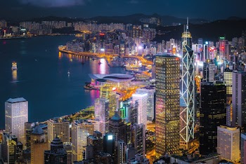 City With High-rise Buildings Viewing Sea during Night Time