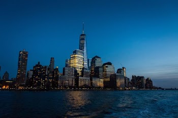 cityscape near body of water under blue sky