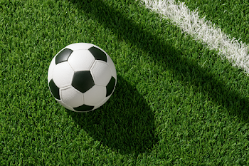 Classic Black and White Soccer Ball on Green Turf