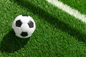 Classic Black and White Soccer Ball on Green Turf