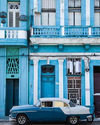 Classic Blue and White Sedan Near Building