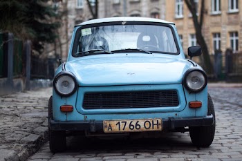 Classic Blue Car Parked Near Fence and Trees