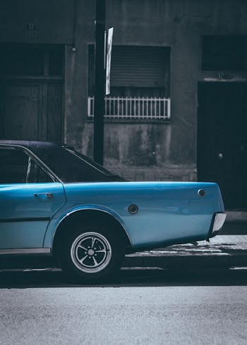 Classic Blue Sedan Parked On Roadside