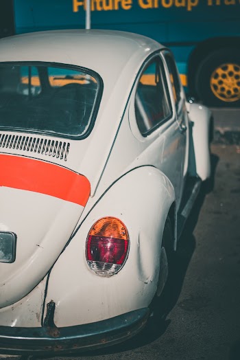 Classic White volkswagen beetle Coupe Parked Near Vehicle