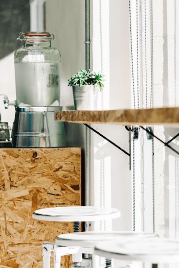 clear and grey beverage dispenser on particle table