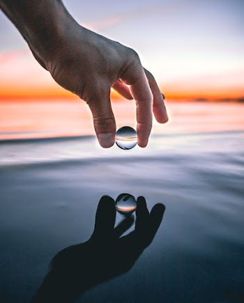 Clear Ball Above Body of Water