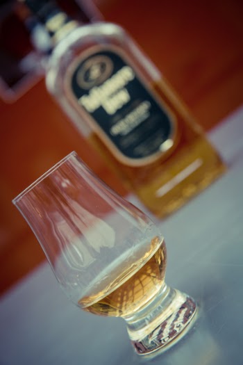 Clear Brandy Glass Near Wine Bottle