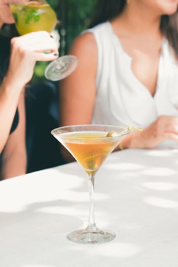 Clear Cocktail Glass Filled With Liquor on White Table