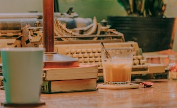 Clear Drinking Cup Near Books