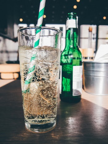 Clear Drinking Glass Filled With White Liquid and White Straw