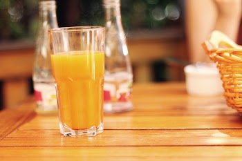Clear Drinking Glass Filled With Yellow Liquid