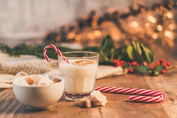 Clear Drinking Glass With Milk Near Candy Cane