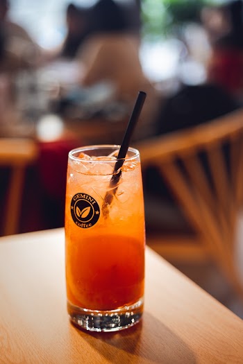 Clear Drinking Glass With Straw on Brown Table