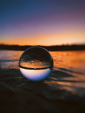 Clear Glass Ball on sand Surface