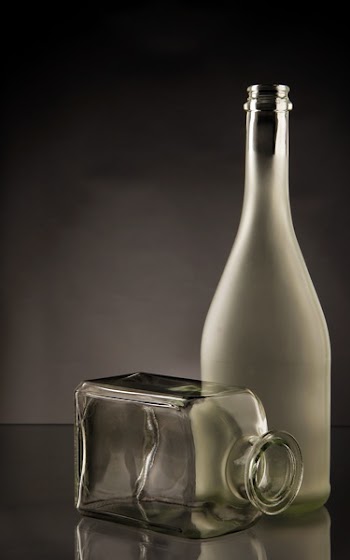 Clear Glass Bottles on Clear Glass-top Table