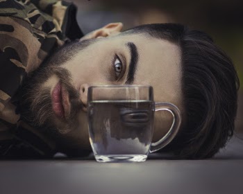 Clear Glass Cup In Front Of Man