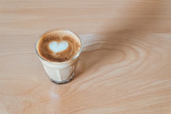 Clear Glass Cup on Brown Wooden Surface