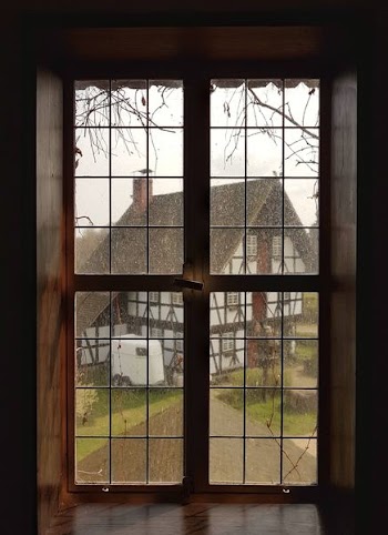 clear glass doors with brown frame inside brown room during daytime