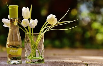 Clear Glass Hugo Bottle With White Flowers