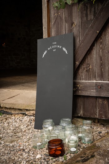 Clear Glass Jars Near Black Board